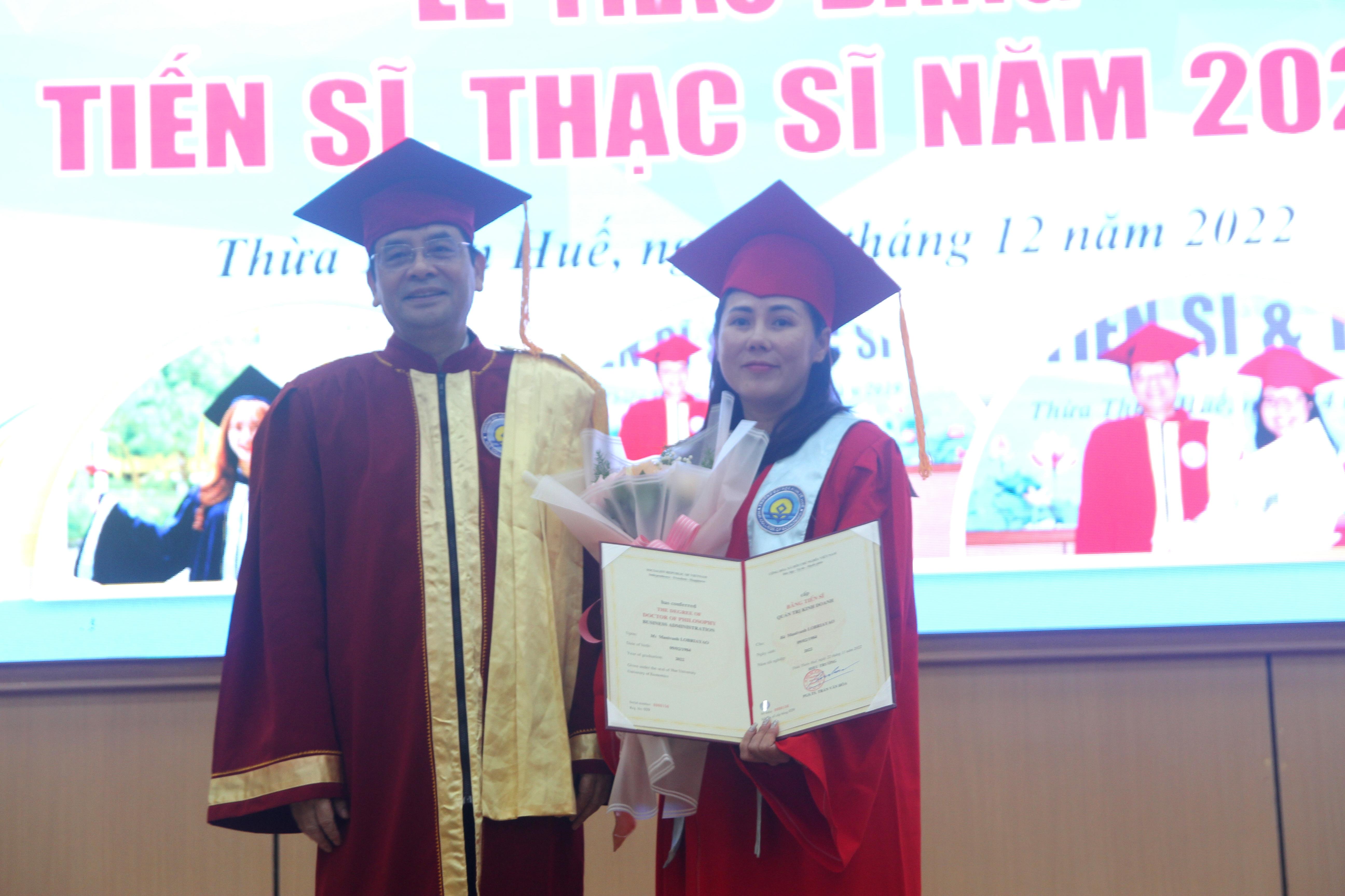 PGS.TS. Trần Văn Hòa - Hiệu trưởng Trường ĐH Kinh tế, ĐH Huế trao bằng tiến sĩ cho bà Manivanh Lobriayao, quốc tịch Lào - tân tiến sĩ nước ngoài đầu tiên do nhà trường đào tạo.