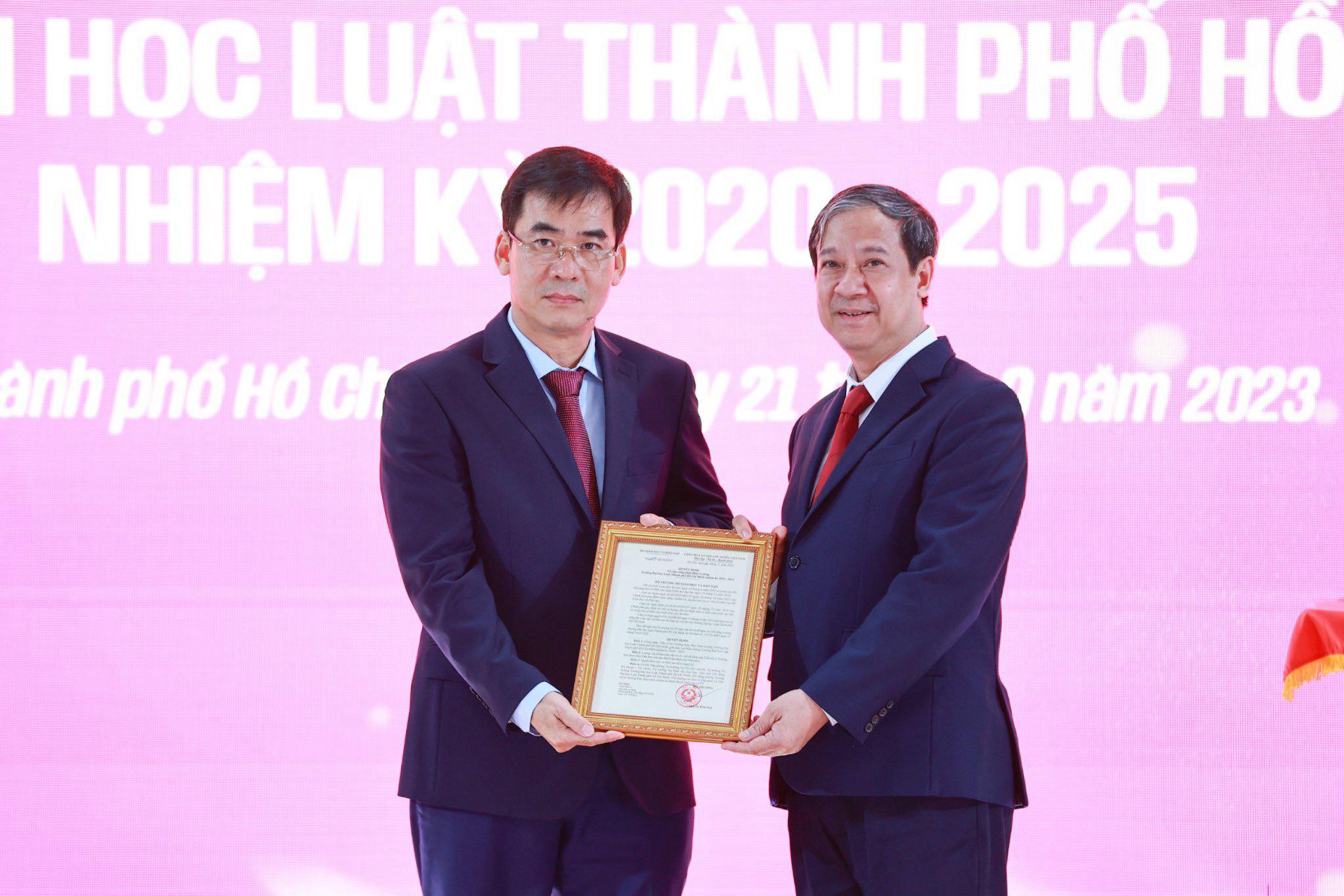 Bộ trưởng Bộ GD&ĐT Nguyễn Kim Sơn (phải) trao quyết định công nhận hiệu trưởng cho TS Lê Trường Sơn. Ảnh: Mạnh Tùng