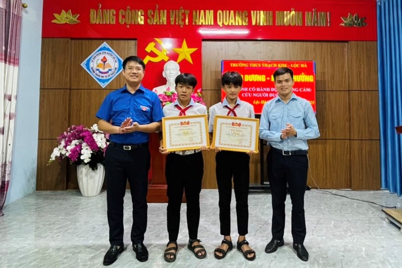 Đại diện Tỉnh đoàn Hà Tĩnh trao thưởng 2 em Phạm Phúc Sinh (lớp 7C) và em Nguyễn Hoàng Phong (lớp 7E, Trường THCS Thạch Kim) vì hành động dũng cảm cứu người. (Ảnh: T.N) ảnh 1