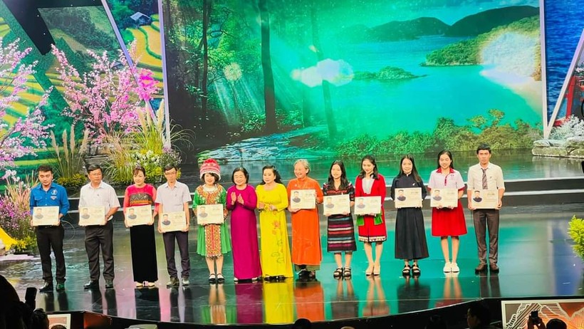 Cô Phan Vũ Diễm Hằng (áo dài màu cam), trưởng nhóm Ong chăm thay mặt nhóm nhận giải thưởng Vừ A Dính 2022.
