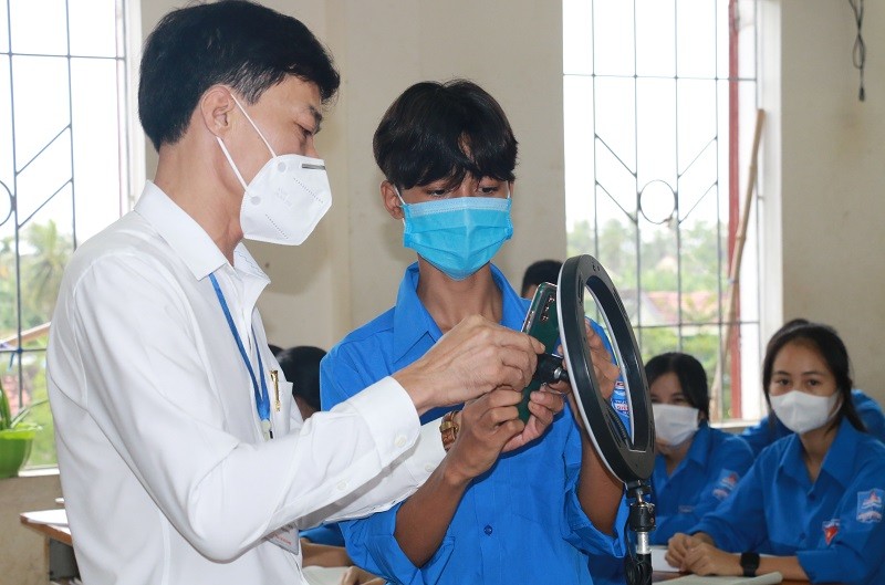 Giáo viên Trường THPT Diễn Châu 4, huyện Diễn Châu, Nghệ An lắp thiết bị để phát trực tiếp tiết học cho học sinh kẹt ở vùng dịch. 