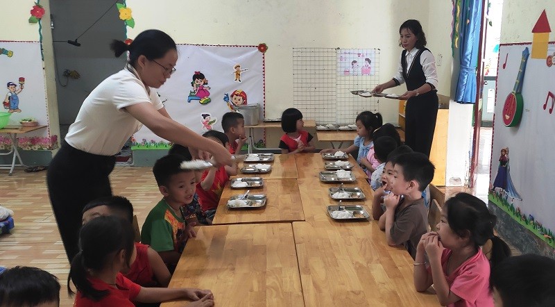 Cô giáo Trường Mầm non Tam Chung chăm sóc bữa ăn trưa cho trẻ.
