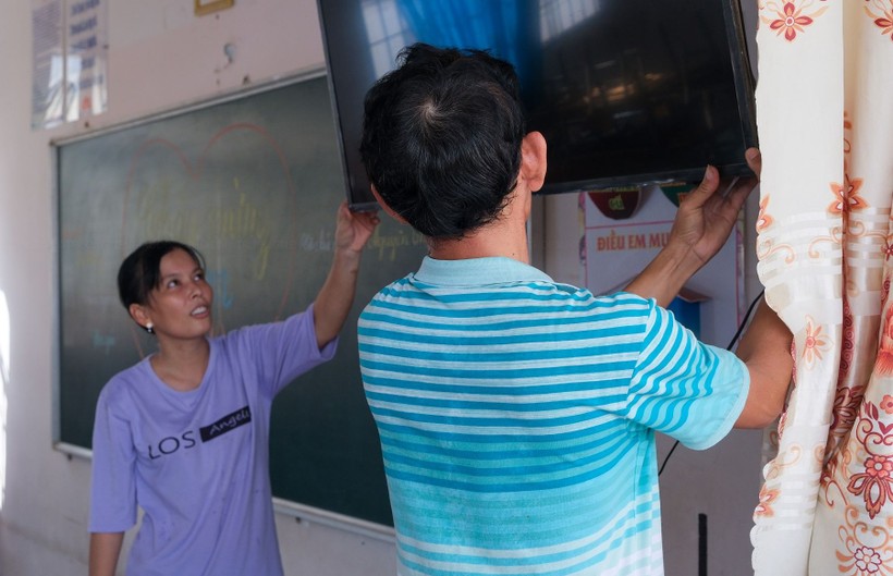 Phụ huynh học sinh một trường tiểu học ở TP Cần Thơ hỗ trợ nhà trường di dời thiết bị học tập sang phòng học mới. ảnh 1