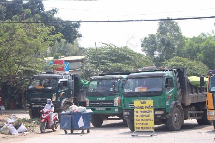 Dân mang biển hiệu, thùng rác cản xe chở đất gây ô nhiễm. Ảnh HT