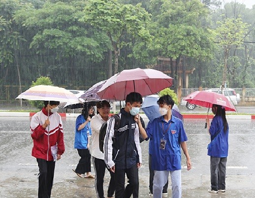 Thí sinh đội mưa đến trường.