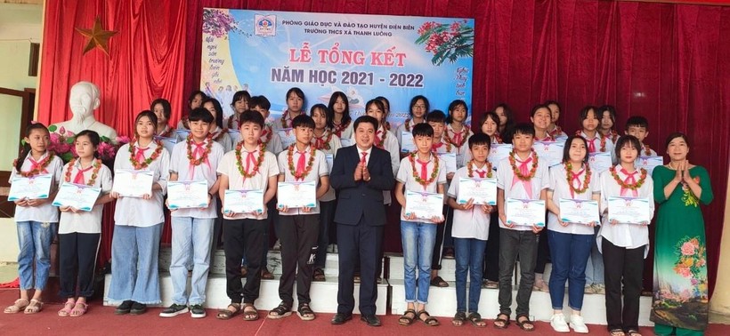 Thầy Nguyễn Đức Hồng (áo đen, đứng giữa) trao phần thưởng cho các em đạt học sinh giỏi các cấp.