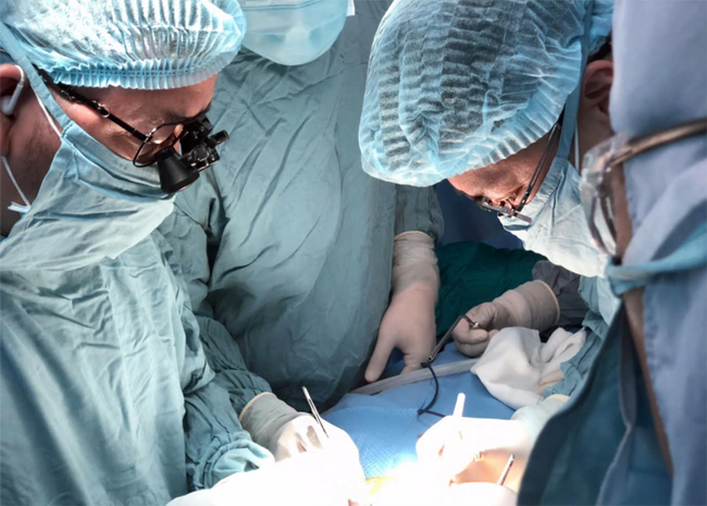 Các bác sĩ BV Nhi Đồng 2 và chuyên gia BV Chợ Rẫy thực hiện phẫu thuật ghép thận vào cơ thể bệnh nhi.
