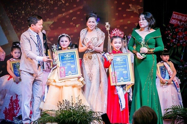 Các vị giám khảo trao giải Á quân cho thi sinh Hoàng Thiên Ngân và Phạm Thị Minh Thư .