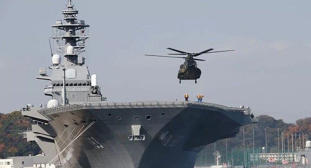 Một chiếc trực thăng chuẩn bị đậu trên mẫu hạm của Lực lượng tự phòng vệ Nhật Bản.