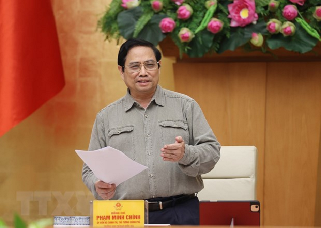 Thủ tướng Phạm Minh Chính chỉ đạo công tác phòng, chống dịch Covid-19. (Ảnh: Dương Giang/TTXVN).