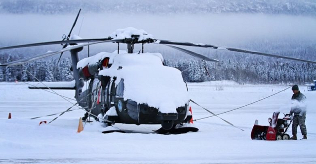 Lực lượng Vệ binh Quốc gia của Quân đội Alaska (Mỹ) dọn tuyết xung quanh trực thăng UH-60 Black Hawk tại Căn cứ Liên hợp Elmendorf-Richardson.