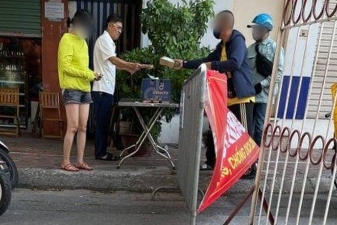 Hình ảnh Bí thư Đảng ủy phường Tân Mai không đeo khẩu trang khi ra nhận hàng hoá bị người dân ghi lại hình ảnh.