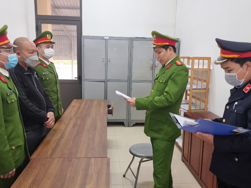 Cơ quan chức năng thi hành các biện pháp tố tụng đối với Phùng Xuân Phong (áo đen ở giữa).