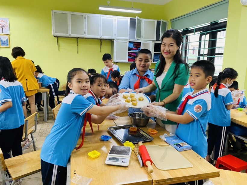 Cô Vũ Thị Thu Hương cùng học sinh tại buổi trải nghiệm làm bánh.