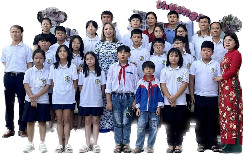 Các em Trịnh Viết Long, Trịnh Viết Sang chụp ảnh cùng tập thể lớp 6A2 KBIS, giáo viên chủ nhiệm và cô Phạm Liên Hương - Giám đốc KBIS (Ảnh TL).