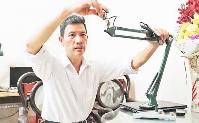 Thầy giáo Đàm Bạch Long với sản phẩm "Máy chiếu vật thể đa năng". Ảnh: báo nhandan.com.vn