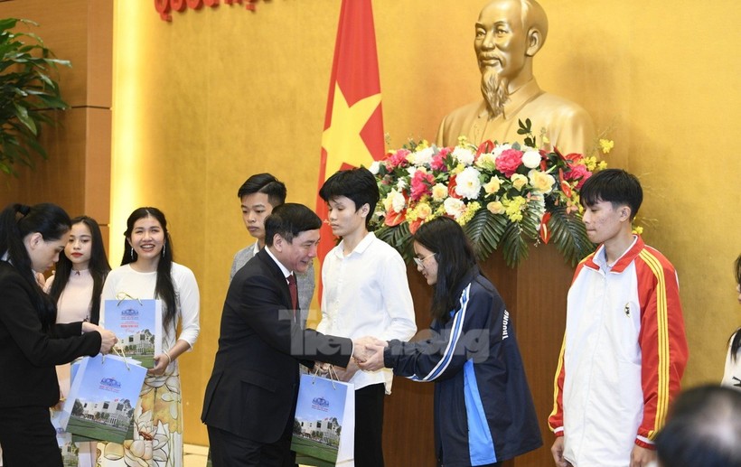 Ông Bùi Văn Cường trao quà của Chủ tịch Quốc hội cho các sinh viên.