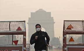 Một người đàn ông phải đeo khẩu trang 
khi chạy bộ tại Delhi