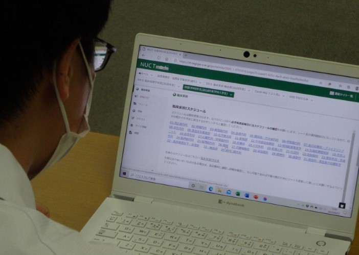 Một sinh viên y khoa tại Trường Đại học Nagoya kiểm tra lịch trình đào tạo và báo cáo bài tập trực tuyến.
