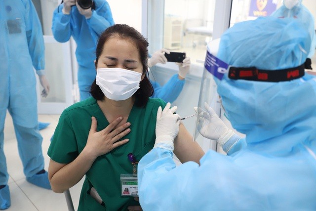 Điều dưỡng Vũ Thị Thanh Thư, khoa Nội tổng hợp là người đầu tiên được tiêm vắc xin tại điểm tiêm Bệnh viện Bệnh Nhiệt đới Trung ương, Hà Nội. Ảnh: Dân trí.