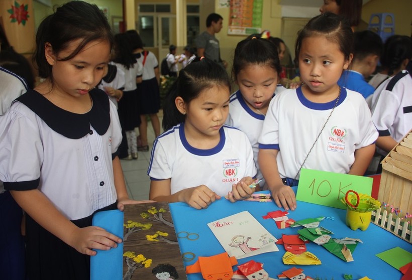 Học sinh Trường TH Nguyễn Bỉnh Khiêm (quận 1) tham quan các gian hàng lưu niệm làm từ đồ tái chế trong ngày hội Xuân của trường