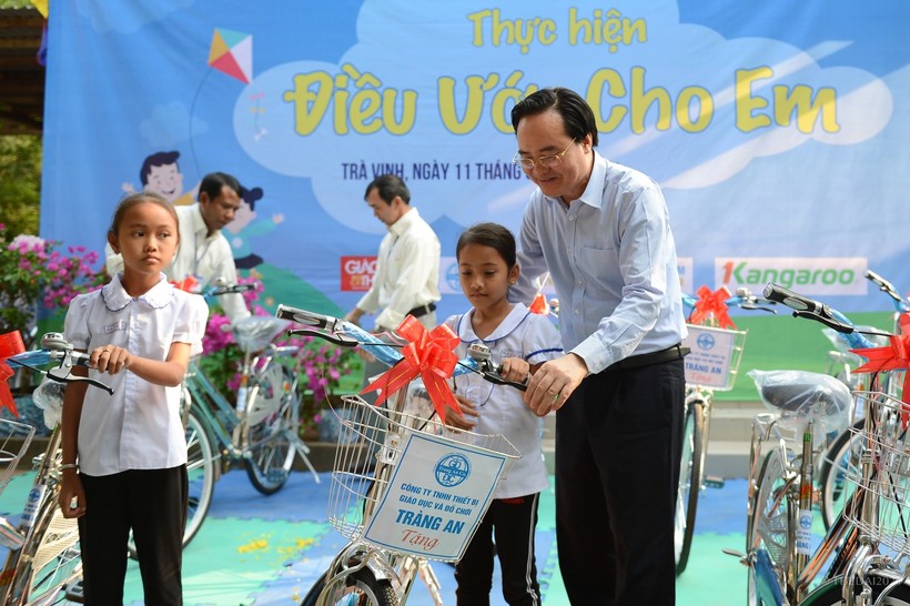 Bộ trưởng Bộ GD&ĐT Phùng Xuân Nhạ trao xe đạp cho HS nghèo Trường TH Đa Lộc A, huyện Châu Thành (Trà Vinh). Ảnh: Thế Đại.