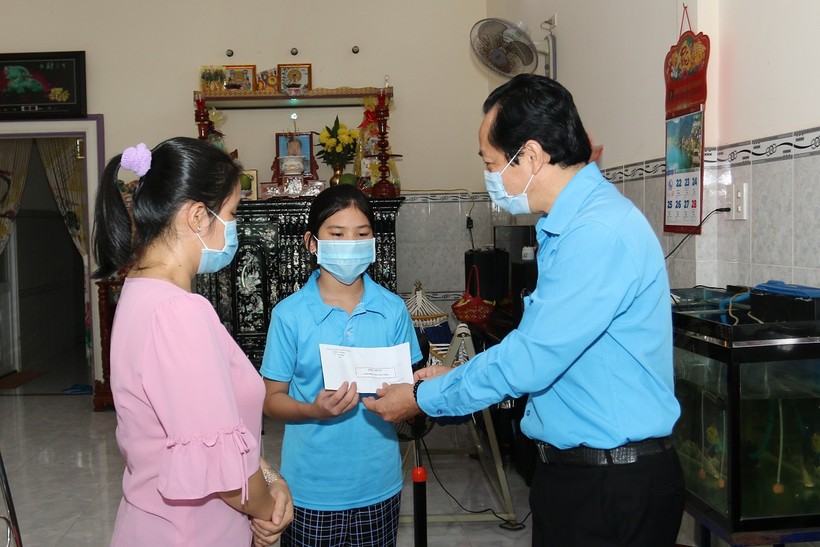 Chủ tịch Công đoàn Giáo dục tỉnh Tiền Giang - ông Lưu Nhơn Đức tặng quà cho em Lê Nguyễn Kỳ Duyên.