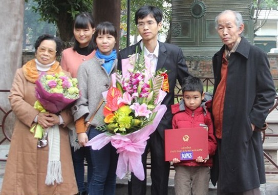 Nhà khoa học trẻ Hoàng Quý Tỉnh (giữa) và gia đình trong ngày vui được công nhận đạt tiêu chuẩn chức danh PGS