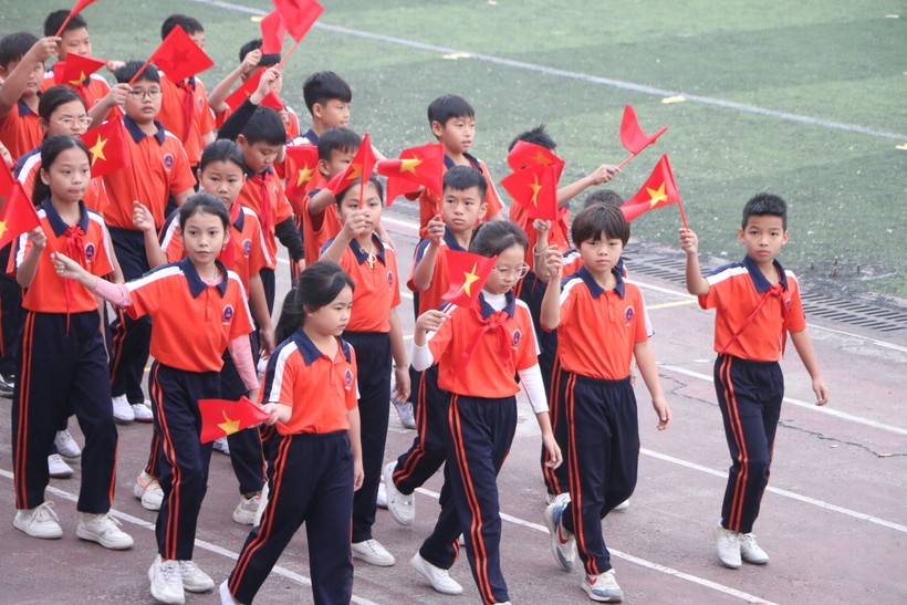 Các vận động viên nhí của Trường Tiểu học An Khánh B đang tiến qua lễ đài.
