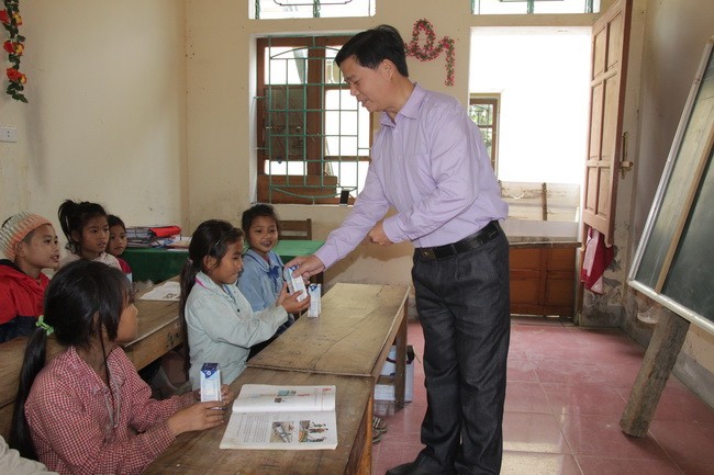 Học sinh Đan Lai tại trường Tiểu học 3 Môn Sơn, Con Cuông, Nghệ An nhận sữa học đường