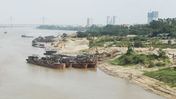 Một bãi tập kết vật liệu xây dựng ven sông Hồng.