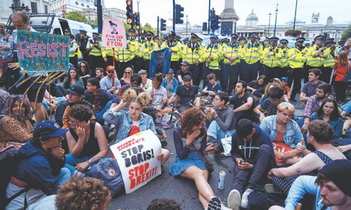 Người biểu tình ngồi xuống đường gần Quảng trường Trafalgar ở trung tâm London vào ngày 31/8/2019 để phản đối chính phủ Anh. Ảnh: AFP