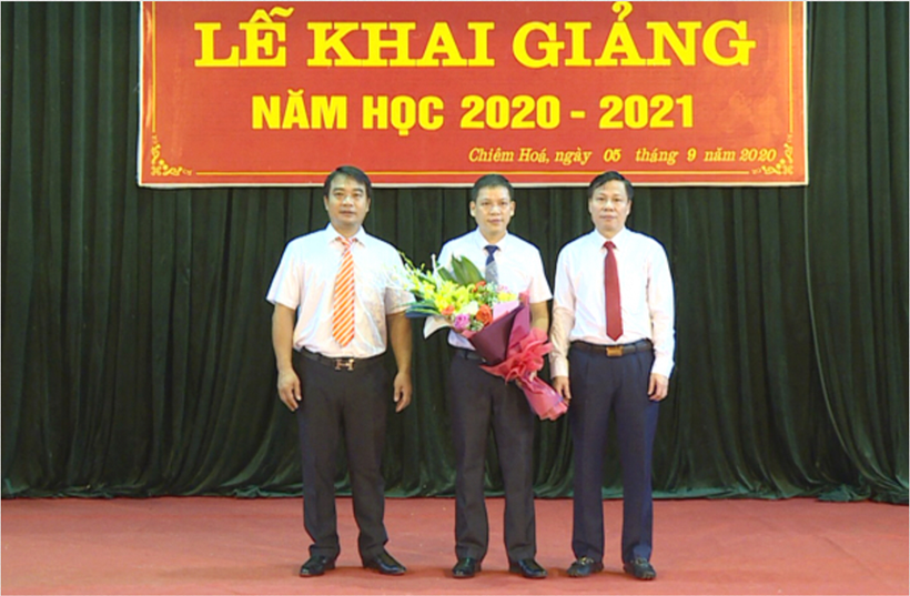 Đồng chí chủ tịch UBND huyện Nguyễn Tiến Dũng tặng hoa chúc mừng thầy và trò trường PTDT Nội Trú THCS huyện