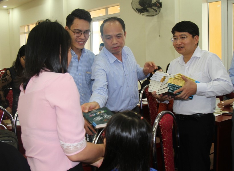 Giám đốc Sở GD&ĐT Hải Phòng Lê Quốc Tiến (áo trắng, đứng giữa) tặng những cuốn sách quý cho cán bộ, giáo viên.